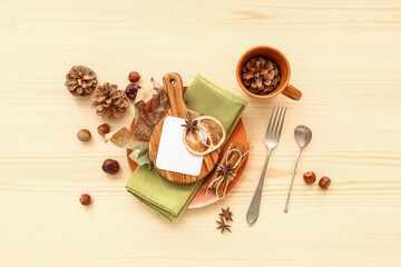 Autumn table setting with different spices, chestnuts and dried orange on wooden background