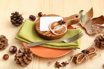 Autumn table setting with different spices, chestnuts and dried orange on wooden background