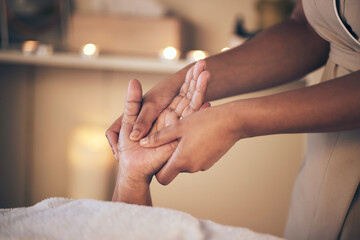 Woman, hands and massage in relax for spa treatment, body care or physical therapy at the resort. Closeup of female person holding hand for stress relief, comfort or zen in healing or reiki at salon - obrazy, fototapety, plakaty