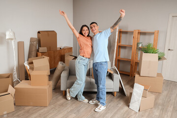 Fototapeta na wymiar Happy young couple hugging in room on moving day
