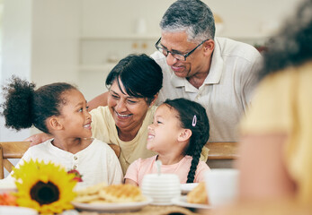 Happy, grandparents and children at table for lunch, dinner and meal together for celebration at home. Family, party and grandpa, grandmother and kids with food for bonding, gathering and holiday