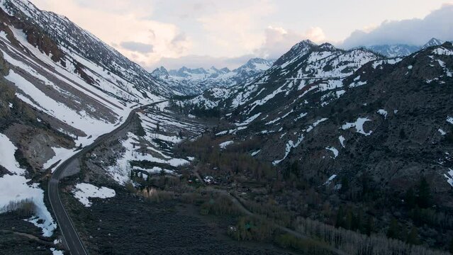 Cinematic aerial shot of snow covered Sierra Nevada mountains in California, USA