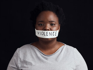 Portrait, censorship and a black woman in protest of domestic violence on a dark background. Freedom, gender equality or empowerment with a serious young female person in studio for human rights - obrazy, fototapety, plakaty