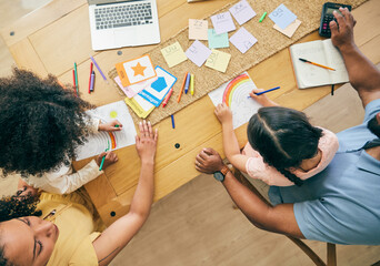 Above, drawing and family together for planning, homework support and strategy for home budget. Table, education and children doing an art project with parents working on bills for the house