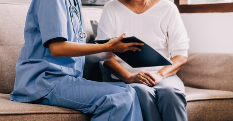 Doctor showing medical card to patient at table in clinic, closeup