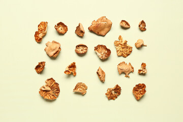 Tasty dried mushrooms on green background