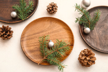 Beautiful table setting with Christmas balls, cones and fir branches on white background