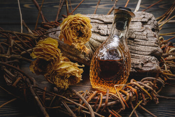 Herbal medicine concept background. Dry natural ingredients and remedy bottle on the wooden table...