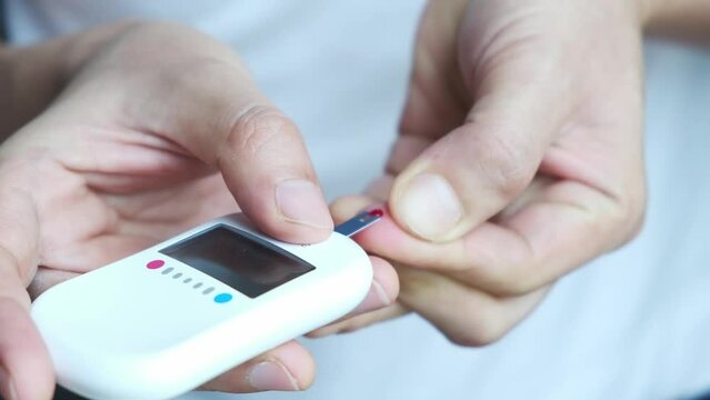  hand of woman check diabetes and high blood glucose monitor with digital pressure gauge. Healthcare and Medical concept