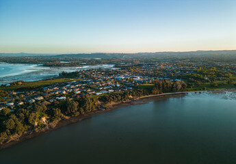 Fototapeta na wymiar Aerial Sunset View of Houses Overlooking the Bay and Mount Manganui from Omokoroa, New Zealand