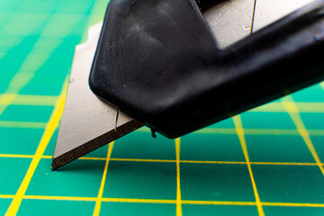 knife macro close-up on green cutting mat