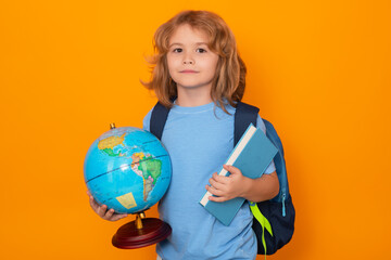 Fototapeta premium Pupil, nerd schoolboy. School boy with world globe and book. Kid boy from elementary school. Little student, smart nerd pupil ready to study. Concept of knowledge, education and learning