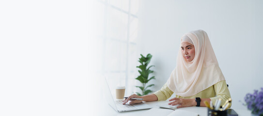 Muslim women use calculators, computers, and laptops to check their accounts at work.