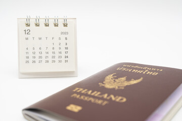 Simple desk calendar for December 2023 and Passport. Calendar and holiday concept with passport isolate on white background.