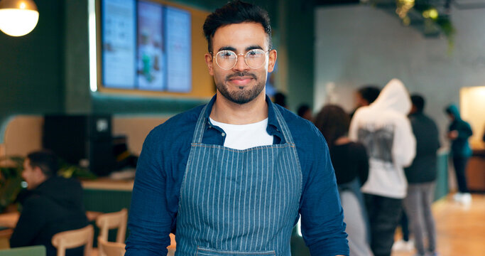 Portrait, man or employee with smile in coffee shop for small business, management or work. Male waiter, glasses and confidence in apron by entrance for welcome, customer and restaurant for service