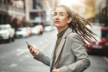 Phone, portrait and business woman in city for social media, email and typing at sunset commute. Mobile, consultant and serious face of professional from Switzerland with glasses in street for travel - obrazy, fototapety, plakaty