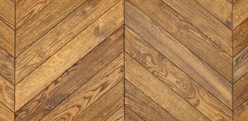 Dark oak wood flooring in a herringbone shape with a clear grain pattern.