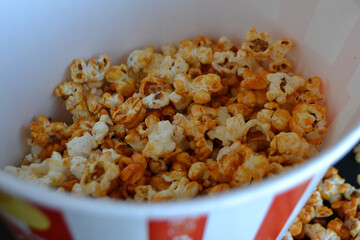 Striped box with popcorn on red background