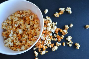 Striped box with popcorn on red background
