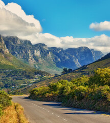 Fototapeta premium Copy space with a mountain pass along the Twelve Apostles in Cape Town, South Africa against a cloudy sky background over a peninsula. Calm and scenic landscape to travel or explore on a road trip