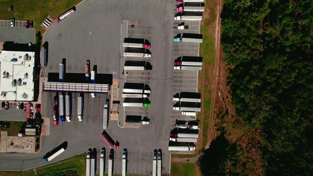 Top down aerial of truck stop in Jasper, Florida USA. Semi trucks fueling tanks. Truck drivers eat, sleep and shower.