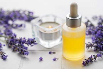 Obraz na płótnie Canvas Lavender natural essential oil and fresh lavender on a white tile background.