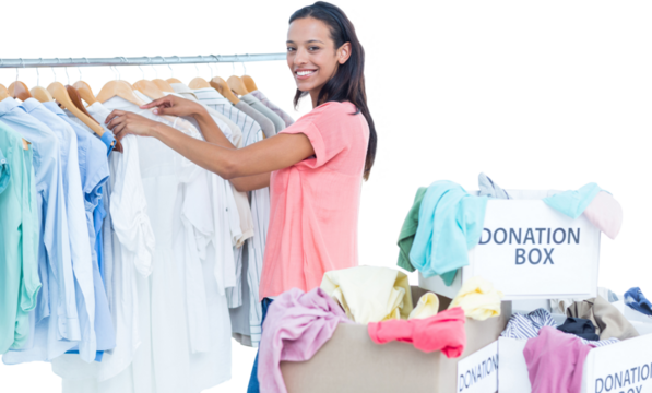 Digital png photo of biracial woman packing clothes in donation boxes on transparent background - Powered by Adobe