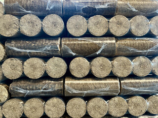 Wood briquettes for heating, packed in plastic film