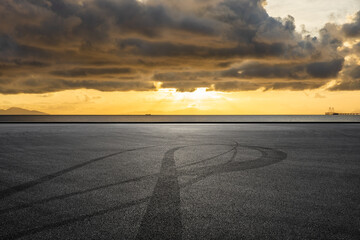 Fototapeta premium Asphalt road and coastline nature landscape at sunrise