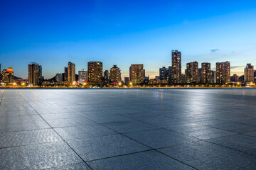 Empty square floor and urban residential area buildings scenery at night