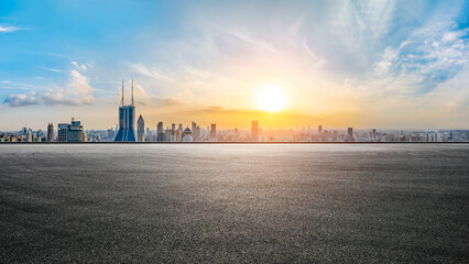 Asphalt road and city skyline with modern buildings at sunset in Shanghai, China. High Angle view.