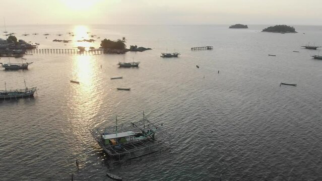 Tanjung binga at Belitung with boats during sunset, aerial
