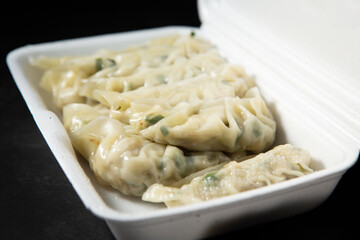 Meat dumplings in a packaging container
