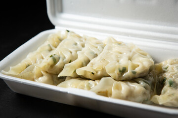 Meat dumplings in a packaging container