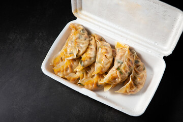 Kimchi dumplings in a packaging container
