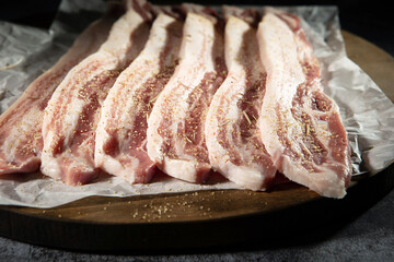 raw pork belly on a wooden board