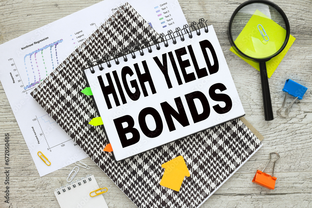 Poster high yield bonds notepad with text. notes in a notepad. magnifying glass