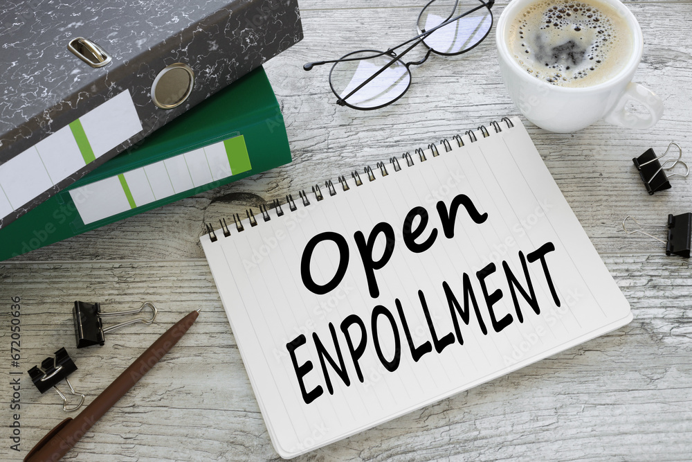 Poster open enrollment. two office folder gray notepad. text on the page