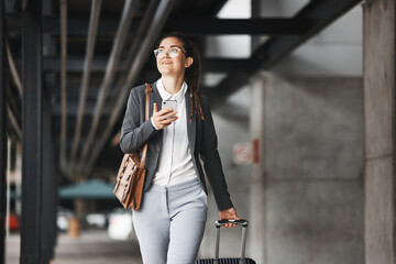 Phone, vision and luggage with a business woman walking in an airport parking lot outdoor in the...