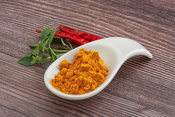 Yellow vibrant curcuma powder in the bowl