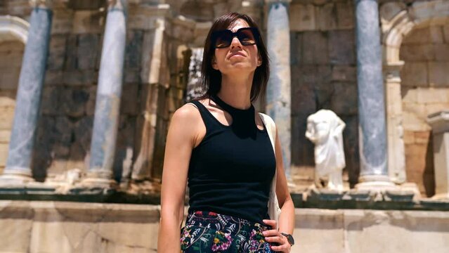 Female tourist explores ruin of the ancient city Sagalassos, heritage of Ancient Rome