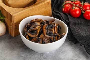 Roasted champignon mushrooms in the bowl