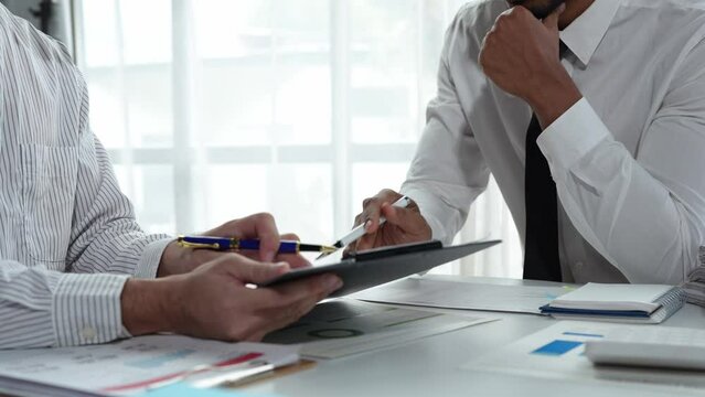 Asian male financial officer or accountant checking investment results Financial budget analysis Planning to summarize results and report to the meeting Audit concept and investment results.