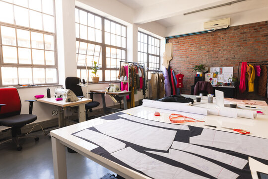 Designs, fabric and tailor's tools in sunny studio