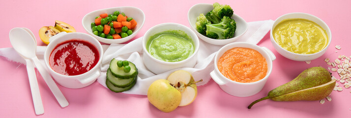 Bowls with baby food on pink background. Healthy eating concept.