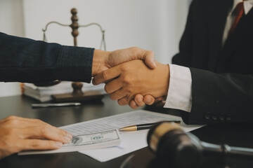 Business and lawyers discussing contract papers with brass scale on desk in office. Law, legal...