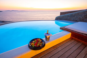Infinity swimming pool in the villa at sunset time, Mykonos, Greece - Powered by Adobe