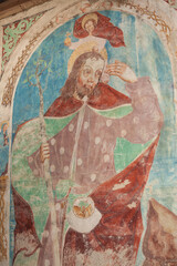 A paint (fresco) on the external wall of the St. Nicolò church in Albions, Italy. The oldest features date back to the era of the transition from late Romanesque to early Gothic.