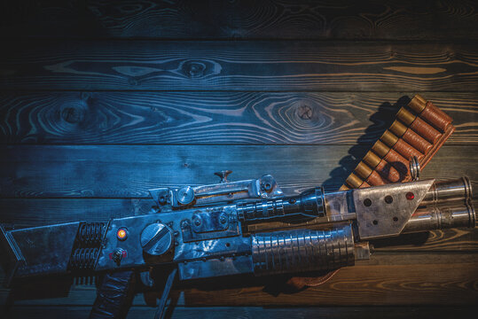Sci fi post apocalypse pump shotgun and gas mask on the survivor table concept background.