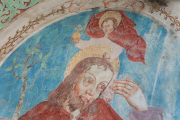 A paint (fresco) on the external wall of the church. The church is dedicated to St. Nicolò  and the oldest features date back to the era of the transition from late Romanesque to early Gothic.